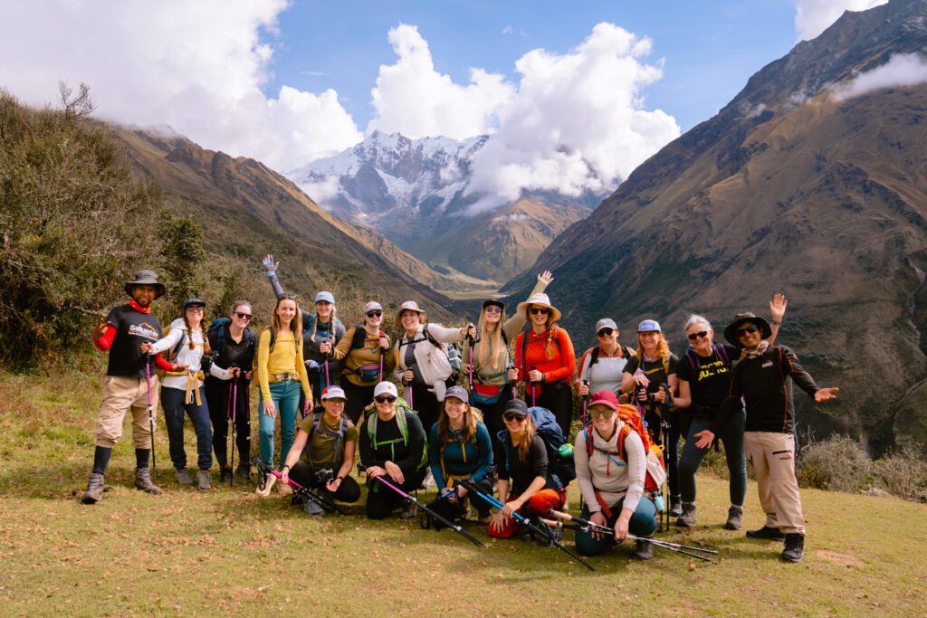 Group photo of people on the Salkantay trek in Peru with the Salkantay mountain in the background